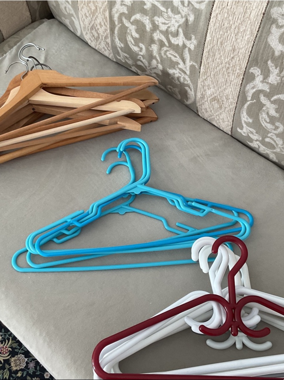 Mixed Closet Hangers in Bright Blue, White, Burgundy, and Natural Wood